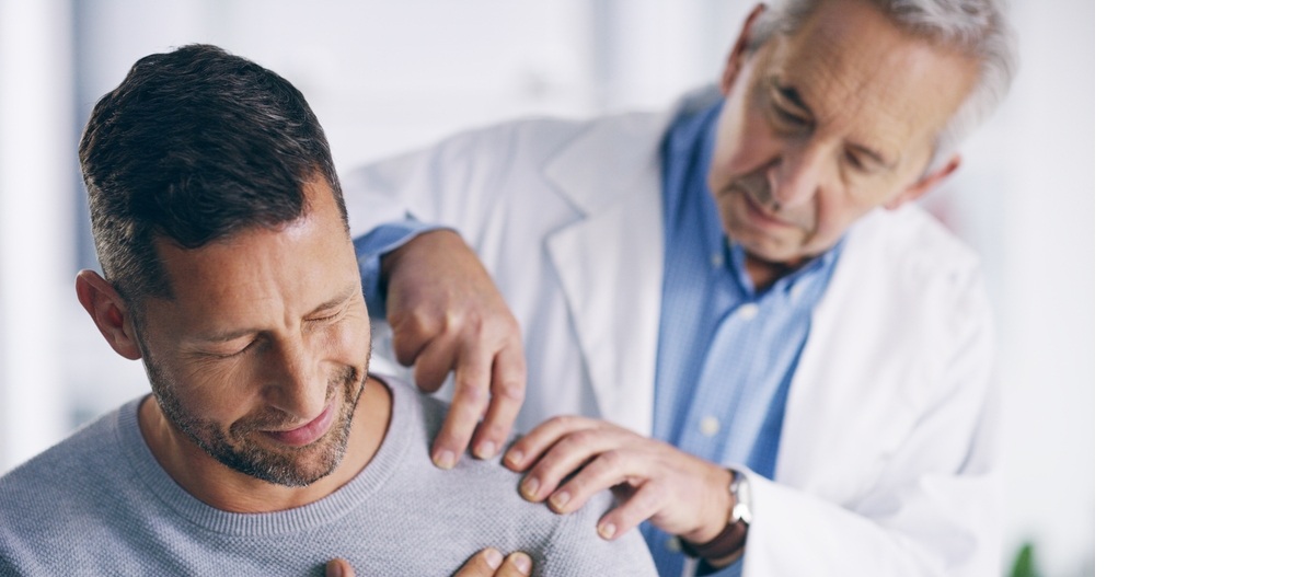 doctor examining a patient with shoulder pain